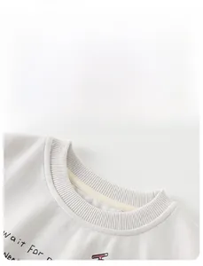 Detail of ribbed crew neck and soft knit fabric with Wait for text on kids sweater