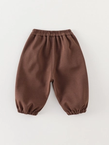Kids minimalist solid color jogger pants in dark brown with elastic waist and ribbed cuffs