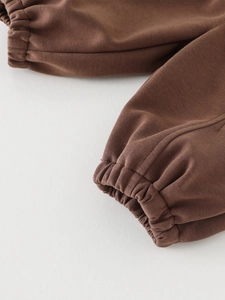 Brown solid color kids jogger pants featuring high-quality elastic cuffs and knit fabric