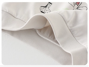 Close-up of thick ribbed cuffs and soft fabric texture on beige toddler sweatshirt