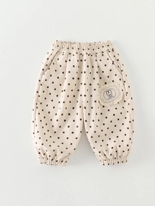 Children's polka dot joggers in beige with cartoon bunny patch and elastic cuffs