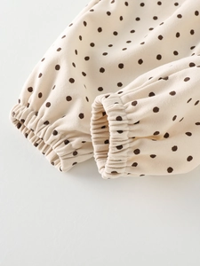 Toddler cream polka dot casual pants featuring elastic ribbed cuffs and soft fabric texture