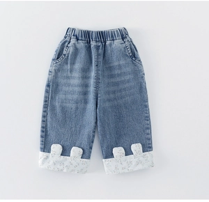 Detailed view of baby girl denim pants with elastic waist and floral rabbit ear cuffs