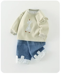 Detail of baby girl sweatshirt with giraffe embroidery and ruffle shoulder trim
