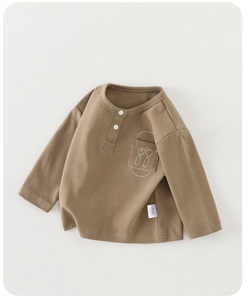 Close-up of brown long-sleeve toddler tee with button collar and fork spoon pocket