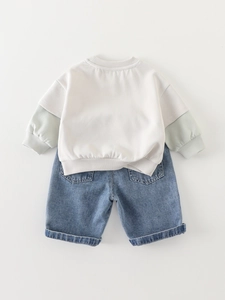 Kids long sleeve cream sweatshirt with green sleeves and blue denim shorts two-piece set