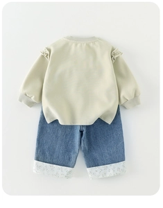 Detail of baby girl ruffle sweatshirt and floral cuff denim pants casual outfit set