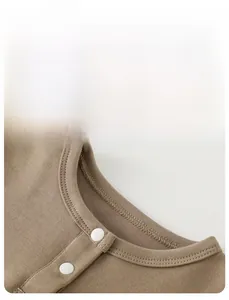 Detail view of cotton baby shirt neckline with white buttons and ribbed finish