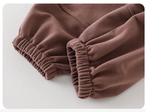 Close-up of elastic ribbed cuffs on brown fleece sweatpants for toddler boys' comfort