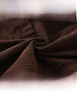 Detailed view of high-density brown corduroy fabric texture for kids trousers