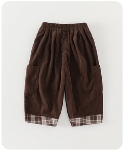 Detailed texture of brown corduroy kids pants with plaid cuff stitching and elastic waistband