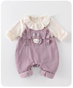 Close-up of baby girl outfit showing ruffle collar and cute rabbit embroidery detail