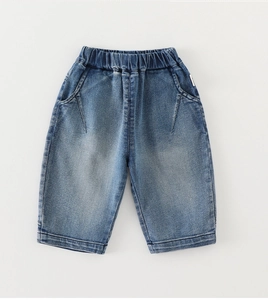 Detail view of elastic waistband and washed blue denim texture on boys' straight-leg jeans