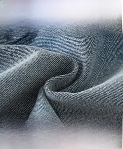 Close-up of dark blue denim fabric texture showing soft, breathable, and anti-pilling weave