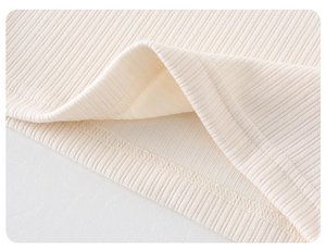 Macro detail of ribbed knit fabric with professional double-needle stitching on the hem