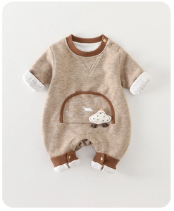Detail of baby cotton jumpsuit featuring cute house prints and soft 3D cloud accessory