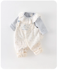 Flat lay of baby girl blue ribbed long sleeve top with lace collar and floral overalls
