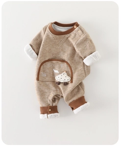 Detail of baby romper with cute mushroom patch and snail print on large chest pocket