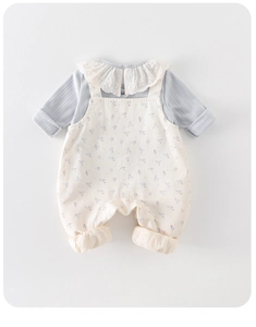 Detail of baby girl floral romper with delicate lace collar and blue ribbed shirt