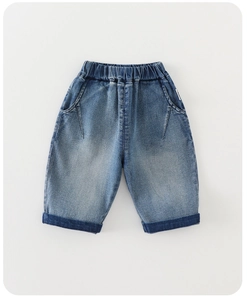 Detailed flat lay of boys blue denim shorts with elastic waist and folded cuffs