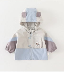 Detail of hooded baby jacket with bear ears, tricolor patchwork, and elastic cuffs