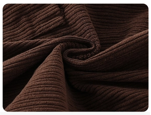 Close-up macro of dark brown corduroy fabric texture for toddler casual pants