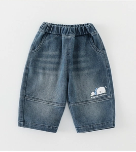 Macro shot of dark blue kids denim jeans with happy ducky print and elastic waist