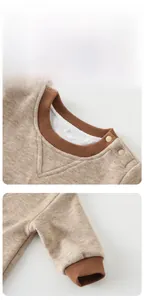 Detailed macro view of oatmeal knit baby bodysuit with brown ribbed neck and resin snaps