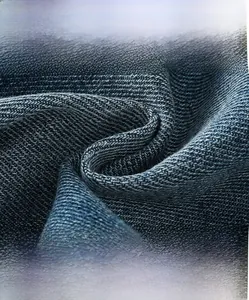 Close-up of high-density blue denim fabric texture showing soft breathable fibers