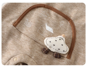 Detail of baby romper with soft knit fabric, pocket and 3D cloud patch decoration