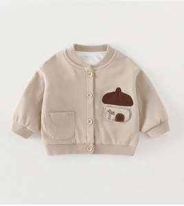 Detail of baby knitted cardigan with waffle texture, wood buttons and cute house patch
