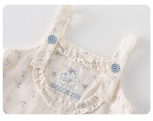 Close-up of floral girls shirt with ruffled collar and cute kitten embroidery detail
