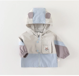 Detail of hooded windbreaker featuring 3D bear ears and a cute cartoon badge design
