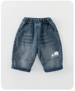 Detail of blue kids denim jeans featuring a cute happy ducky print and elastic waist