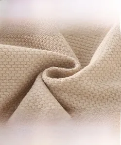 Detailed macro view of cream waffle knit fabric texture for kids cardigan jackets