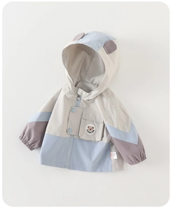 Detail of color-block kids windbreaker showing a zip front, brand logo, and cute hood ears