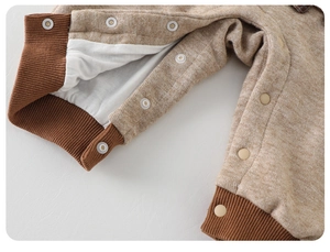 Close-up of baby romper crotch with snap buttons and soft ribbed cuffs on legs