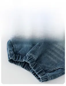 Detailed macro view of elastic cuffs on blue washed denim jeans for boys in soft lighting