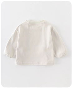 Rear view of light beige long-sleeve cotton shirt for girls with ribbed cuffs