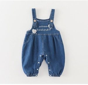 Detail der Baby-Jeans-Latzhose mit Herz-Spitze-Patch, Trägern und Metalldruckknöpfen am Schritt