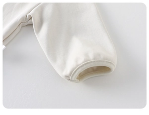 Detail shot of soft white cotton long sleeve cuff with elastic ribbed texture for girls