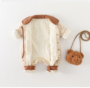 Detail of baby quilted romper featuring cute bear prints and brown corduroy trim finish