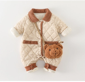 Detail of baby quilted romper with bear patterns and soft corduroy trims on cuffs