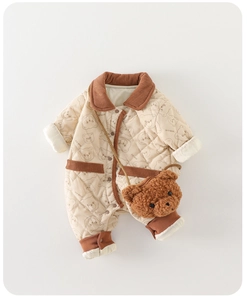 Close-up of quilted cotton baby romper with bear prints and corduroy collar detail
