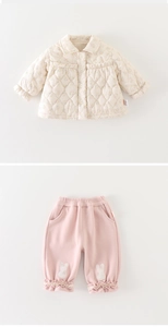 Detail of baby floral quilted jacket and pink trousers with rabbit embroidery