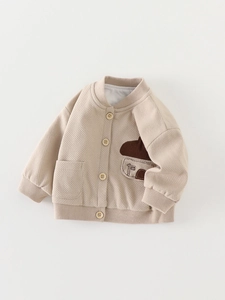 Beige waffle knit cardigan for toddler boys featuring mushroom patch and brown buttons