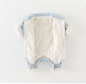 Detail view of baby quilted romper showing snap closure and soft cotton inner lining