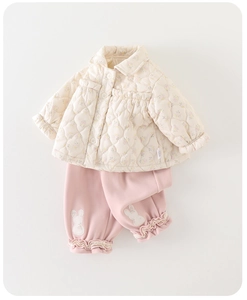 Detail of baby winter floral quilted jacket and pink trousers with bunny patches
