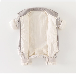 Detail view of thickened baby snowsuit featuring tree print and corduroy trim lining