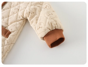Close-up of baby romper quilted corduroy fabric with rib cuffs and bear prints